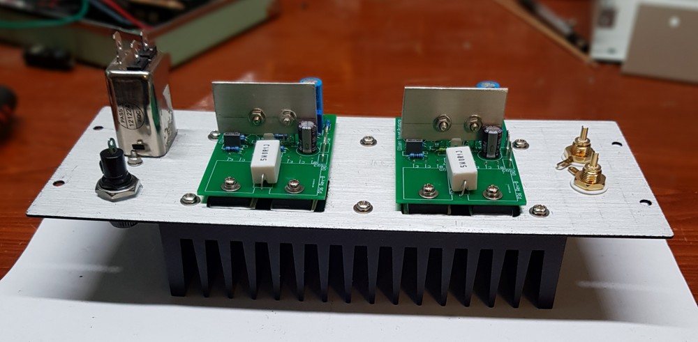 The rear panel ready to go after mechanical assembly. The heatsink is 1.1 K/W and gets noticeably warm with use. If you look closely, you can see the output transistors are mounted directly to the heatsink through holes cut out in the back panel.