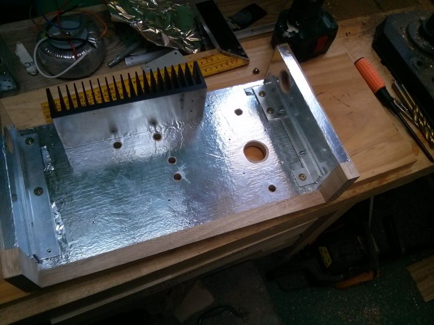 Aligning the sides and bottom-piece brackets before permanently attaching the top to the sides. I had to use folded pieces of aluminium foil as shims for fine adjustment of the angle.